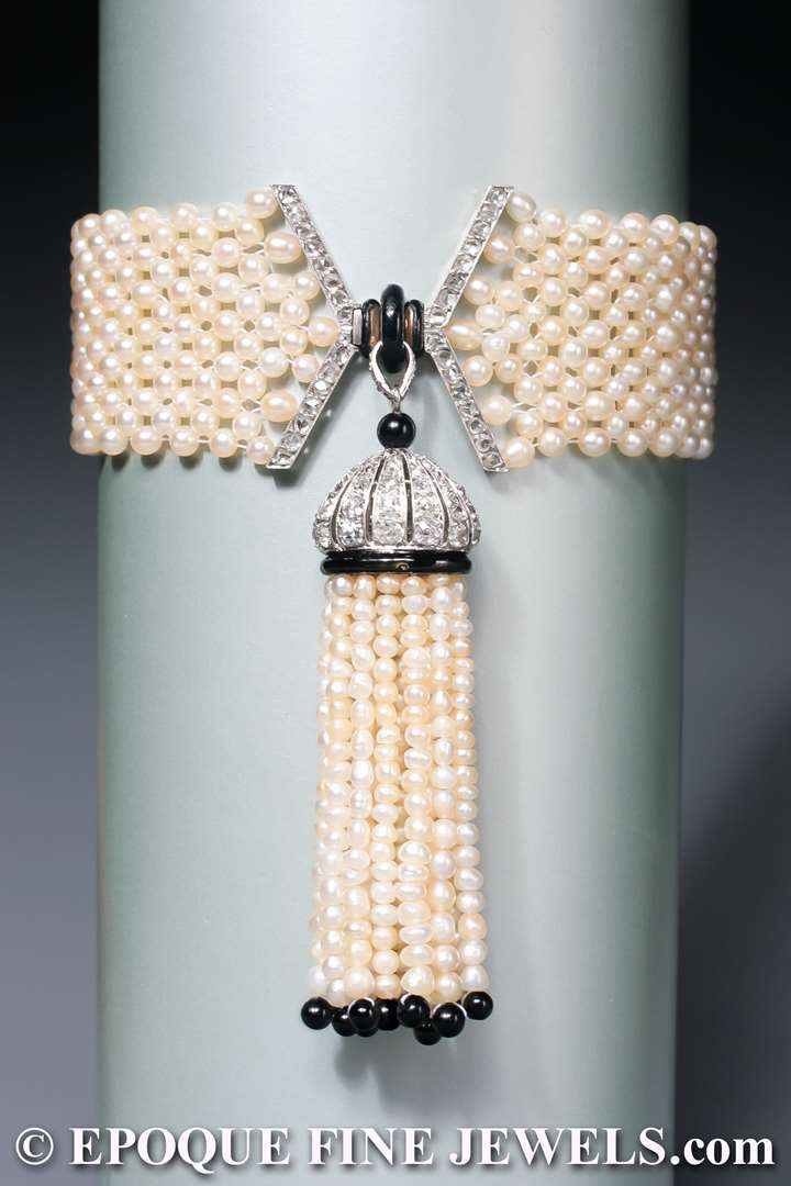 An early Art Deco natural pearl, enamel, onyx and diamond tassel bracelet